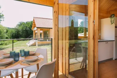 a kitchen and dining room with a table and chairs at Cabañas de Allariz in Allariz