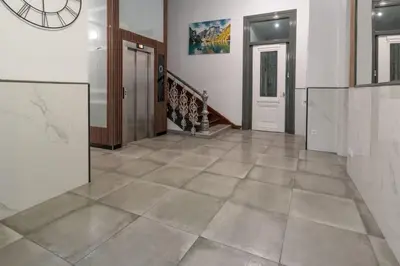 a hallway with a tile floor and a staircase at Apartamento Paseo Malecón Planta 1 in Monforte de Lemos