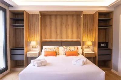 a bedroom with a large white bed with two lamps at Loureira in Pincelo