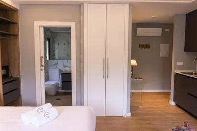 a bedroom with a white closet and a bathroom at Caño in Pincelo