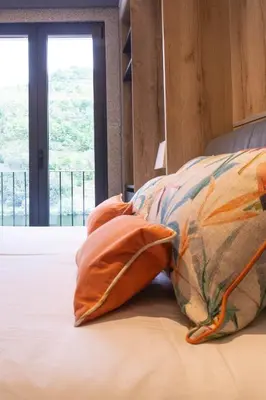 a bed with two pillows on it with a window at Caño in Pincelo