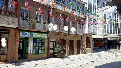 a street in a city with flags and buildings at Apartamento Ático Select Real Caldas de Reis in Caldas de Reis