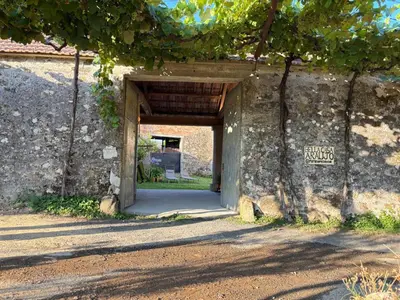 an entrance to a building with a stone wall at Bella Casa Araujo 2 in Teo