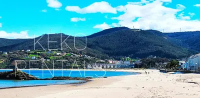 a view of a beach with a mountain in the background at Apartamento Maruja Mallo in Viveiro