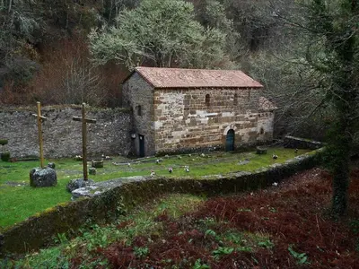 an old stone building with birds standing around it at Stone Cottage O CEBREIRO in Curtis