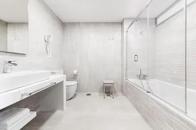 a bathroom with a toilet and a sink and a shower at Apartahotel A Cetárea in Burela de Cabo