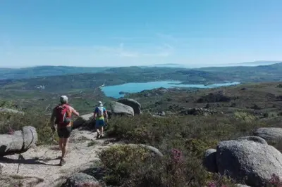 two people walking down a trail on a mountain at Apartamento do Xurés in Maus de Salas