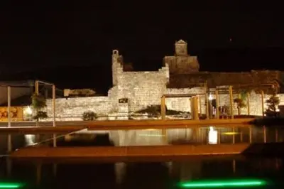 a large stone building at night with a building at Duplex Familiar in Ribadavia