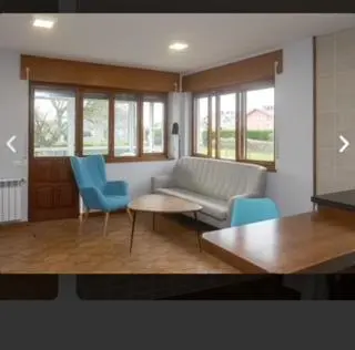a living room with a couch and chairs and a table at APARTAMENTOS BARCELLA TAPIA in Tapia de Casariego
