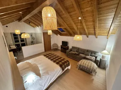 a bedroom with a bed and a couch at Casa Rural As Bodegas - Villa Rustica Asturias - Boal in Boal