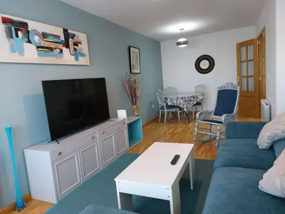 a living room with a couch and a flat screen tv at Cozy Apartment Ponferrada 109 m², Parking in Ponferrada