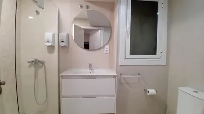 a white bathroom with a sink and a mirror at AMPLIO PISO LUMINOSO CERCA DEL CAMINO Y CATEDRAL C3 in Santiago de Compostela