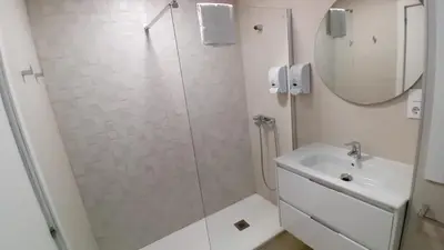 a bathroom with a shower and a sink and a mirror at Amplio piso con vistas en la entrada del camino C4 in Santiago de Compostela