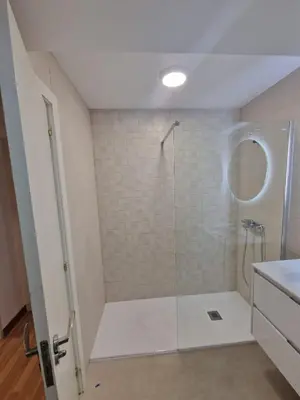 a bathroom with a shower with a glass door at Amplio piso con vistas en la entrada del camino C4 in Santiago de Compostela