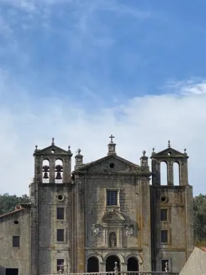 an old church with two towers on top of it at Apartamento Padrón Centro P1 by URent in Padrón
