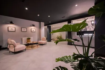a waiting room with two chairs and a table at U-Hotel Darío Lugo in Lugo
