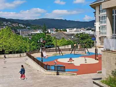 a child walking around a playground in a city at Viveiro Histórico 2 in Viveiro