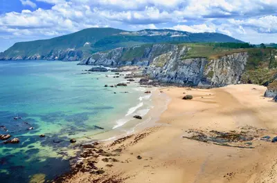 an aerial view of a beach with cliffs at The Cliffs - Sunset Village Beach 1C in Viveiro