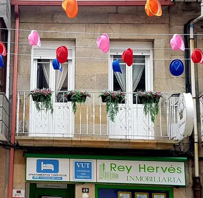 a group of balloons hanging from windows on a building at Apartamento Loft III Select Real Caldas de Reis in Caldas de Reis