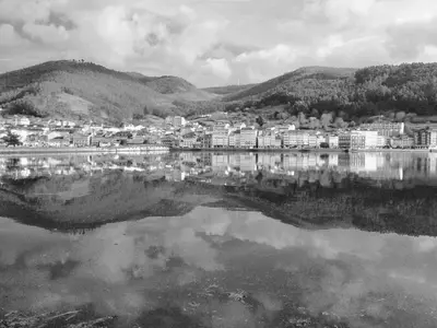 a black and white photo of a city next to a lake at The Cliffs - Sunset Village Beach 3E in Viveiro