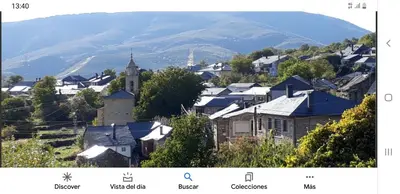 a town with a church and a mountain in the background at Casa Cesar in Lubián