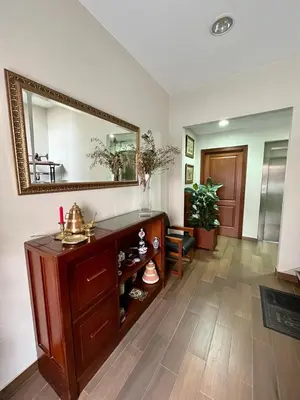 a living room with a mirror and a wooden dresser at Piso en pleno centro de Miño derecha in Miño