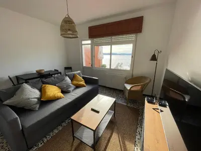a living room with a couch and a table at Oktheway Perbes Beach Vintage in Boebre