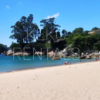 a beach with a sign that says love on it at Casa Carmelo in Viveiro
