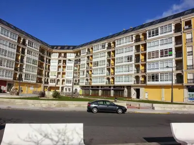 a car parked in front of a large apartment building at Apartamento Marexada Foz in Foz