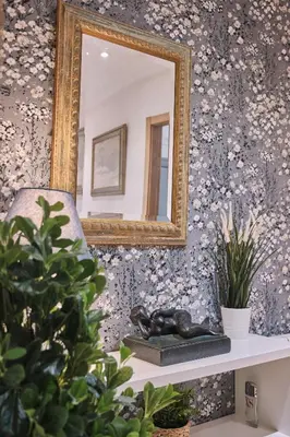 a mirror on a wall with a chair and a statue at Pensión A Solaina 2 in O Pino