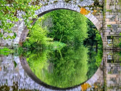 a stone bridge over a body of water at Apartment in Ourense near Thermal Baths in Ourense