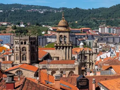 an old building with a clock tower in a city at Apartment in Ourense near Thermal Baths in Ourense