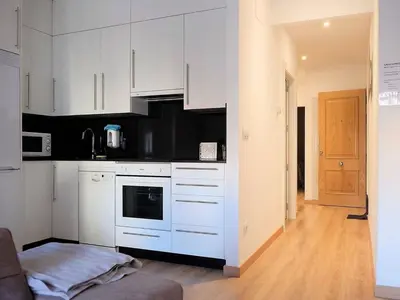 a kitchen with white cabinets and a stove top oven at Apartment in Ourense near Hot Springs in Ourense