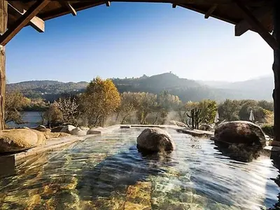 a swimming pool with rocks in the water at Apartment in Ourense near Hot Springs in Ourense