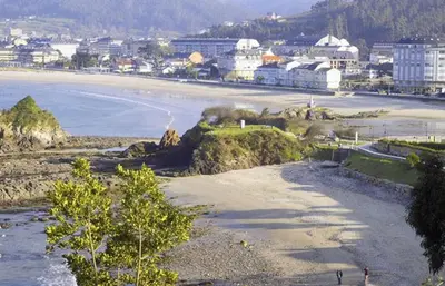 a view of a beach with a city in the background at Alojamientos Viveiro - Ático Playa de Covas in Viveiro
