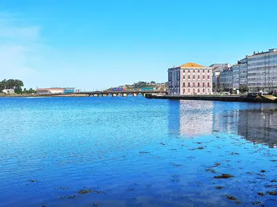 a large body of water with buildings and a bridge at Indiano 1K in Viveiro