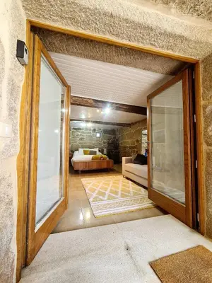 a room with a door to a bedroom with a bed at A aira da xoaniña in Allariz