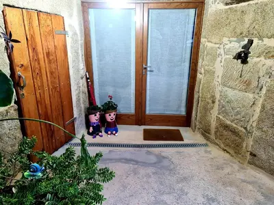 two people standing in front of a door at A aira da xoaniña in Allariz