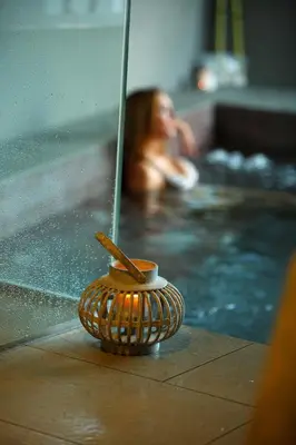 a woman in a swimming pool with a jacuzzi at Hotel Las Sirenas in Viveiro