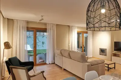 a living room with a couch and a chair at Yuhom, casas con alma, Xacedos 1 in Miño