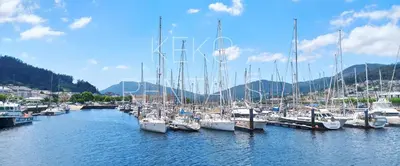 a bunch of boats docked in a harbor at La Casa de Ana in Viveiro