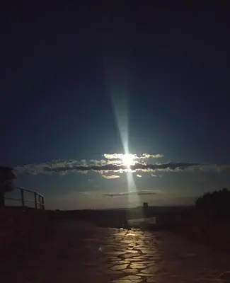 a sun shining in the sky over a body of water at O Busto Aldea Rural, Apartamento HORNO 1 in Puebla del Brollón