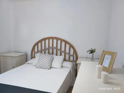 a bedroom with a bed and a table with a mirror at Casa Dina in Carballino
