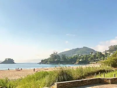a view of a beach with people on it at The Cliffs - Montmar in Viveiro