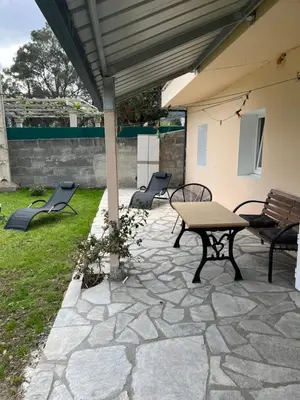 a patio with a table and chairs under a roof at Viviendas uso turístico REME II in Foz